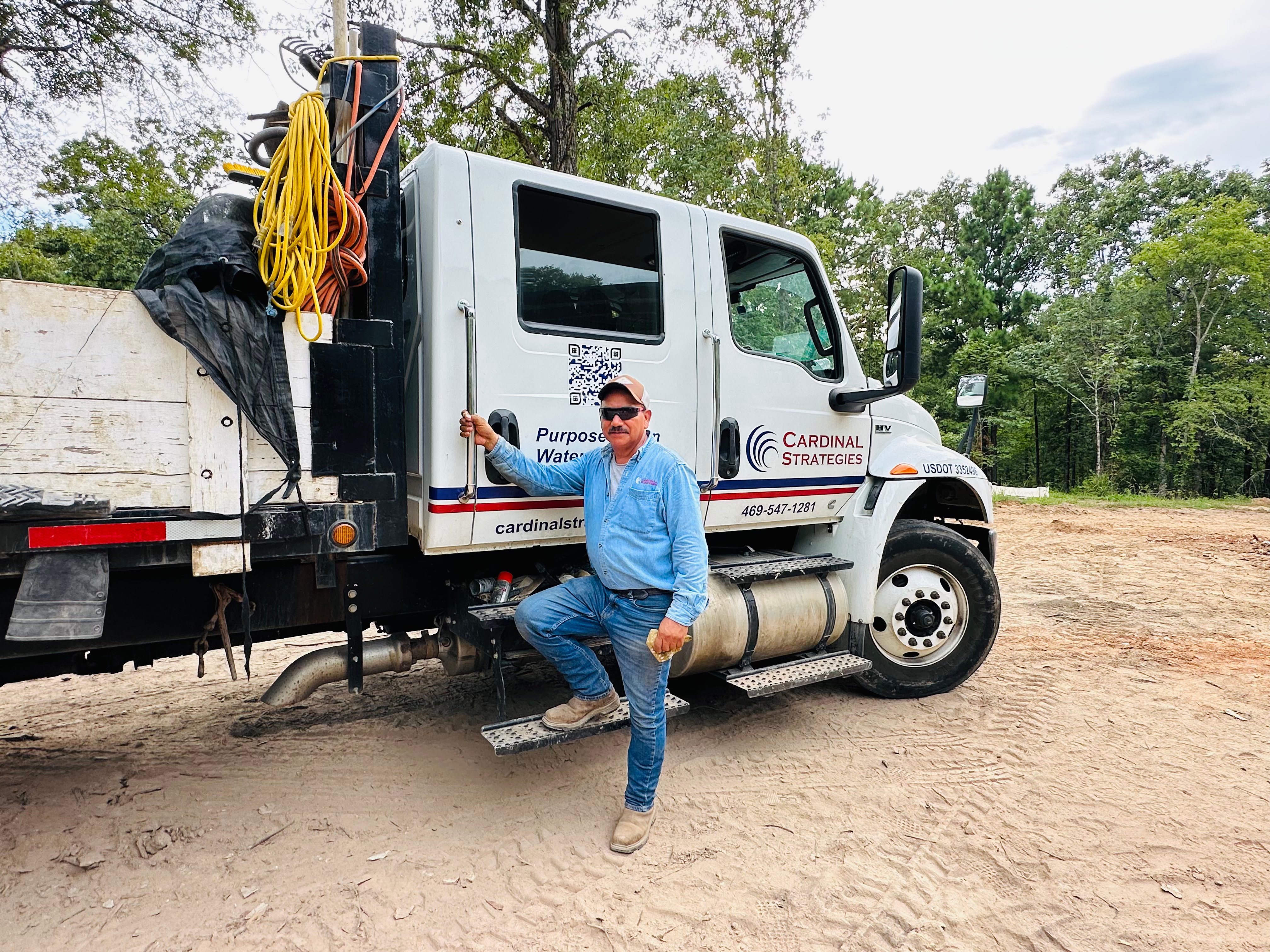 Miguel Sr. standing with Cardinal Strategies truck
